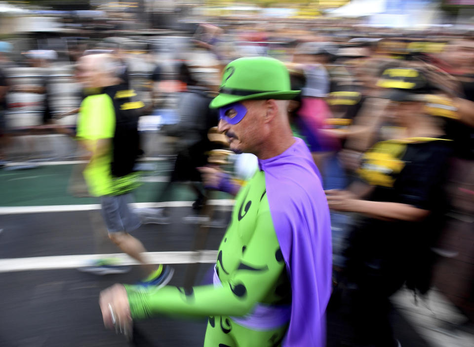 A man dressed in a costume of The Riddler competes the Batman Inaugural 5K run on Batman's 80th anniversary at Grand Park on Saturday, Sept. 21, 2019, in Los Angeles. (Keith Birmingham/The Orange County Register via AP)