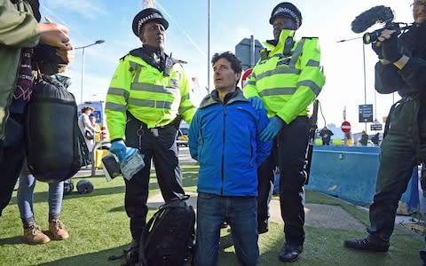 A man is arrested by police officers from the DLR station after activists staged a 'Hong Kong style' blockage of the exit from the station to City Airport - Credit: Kirsty O'Connor/PA