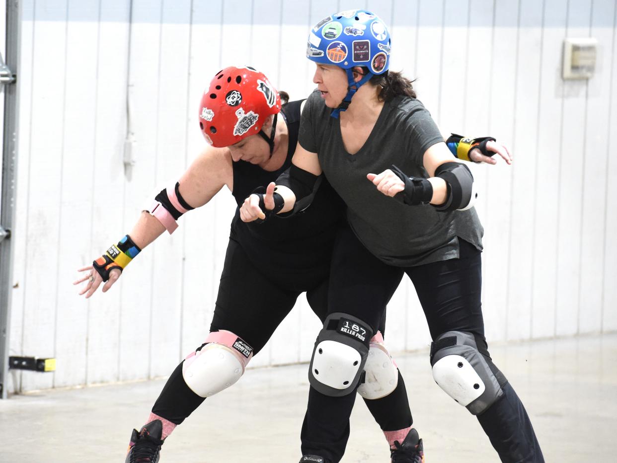 Lora Dattilio and Heather Cole battle on the track at a roller derby practice Thursday Feb. 9 at the Rockingham County Fairgrounds. They are both members of the Rocktown Rollers.