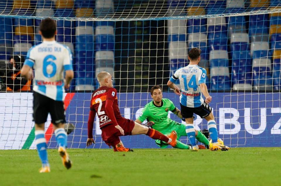 Napoli’s Dries Mertens slides home the third goal against Roma.