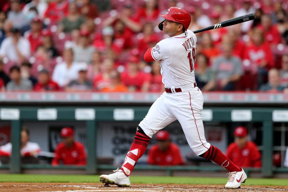 Cincinnati Reds first baseman Joey Votto (19) hits a sacrifice groundball to score Cincinnati Reds right fielder Nick Castellanos (2) (not pictured) during the first inning of a baseball game against the Milwaukee Brewers, Wednesday, June 9, 2021, at Great American Ball Park in Cincinnati. 