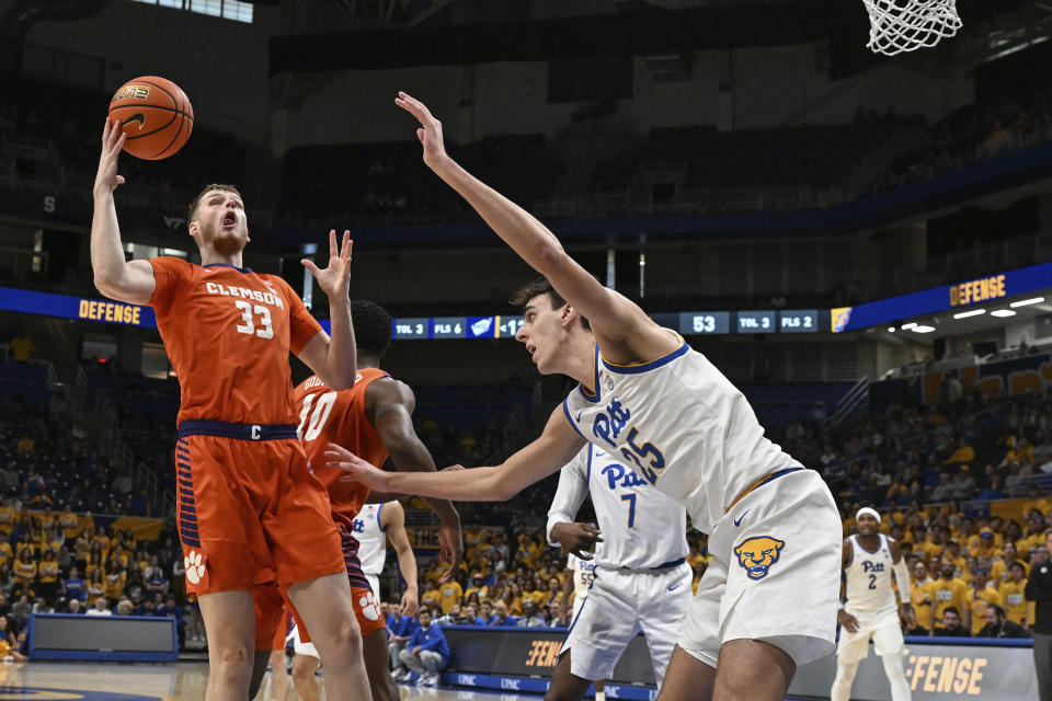 Clemson forward Bas Leyte (33) pulls down a rebound in front of Pittsburgh forward Guillermo Diaz Graham during the second half of an NCAA college basketball game, Sunday, Dec. 3, 2023, in Pittsburgh, Pa. (AP Photo/Barry Reeger)