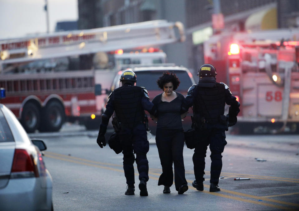 A protester is detained, Monday, April 27, 2015, following the funeral of Freddie Gray in Baltimore. (AP Photo/Matt Rourke)