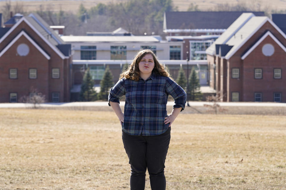 Mary Goddard poses outside the Sununu Youth Development Center, Tuesday, March 23, 2021, in Manchester, N.H. Goddard, a former intern at New Hampshire’s youth detention center says a supervisor suggested she destroy her notes and lie about a teen’s sexual assault allegation. And though she reported the boy’s claim to state investigators and police, it wasn’t included in an annual report that state officials submitted to the federal government.(AP Photo/Charles Krupa)