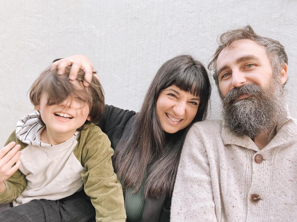 Author Lana Katsaros, her partner, and her son smiling