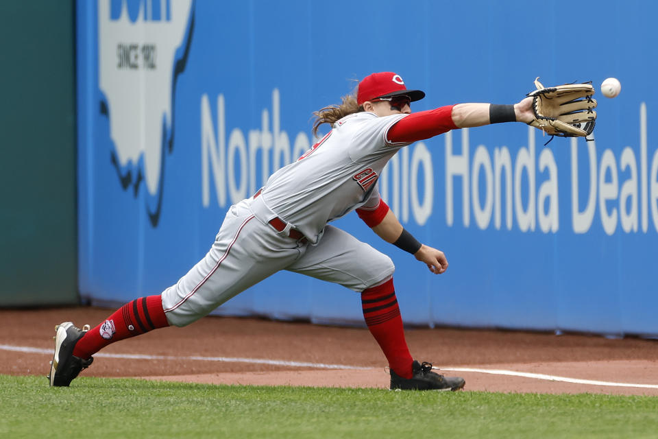 Cincinnati Reds' TJ Friedl makes a running catch for an out hit by Cleveland Guardians' Myles Straw during the first inning of a baseball game, Thursday, May 19, 2022, in Cleveland. (AP Photo/Ron Schwane)