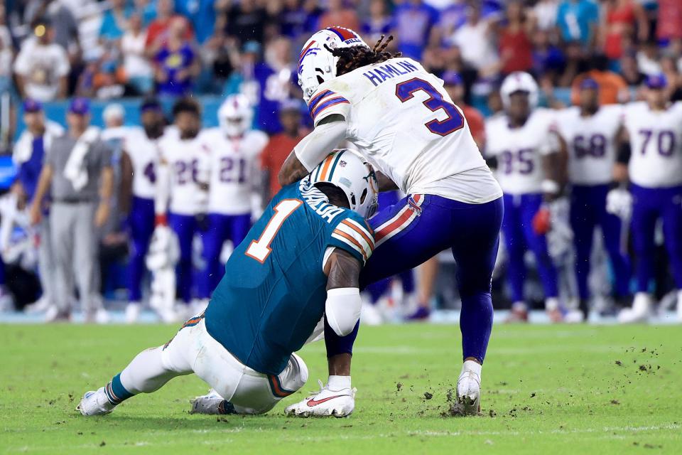 MIAMI GARDENS, FLORIDA - SEPTEMBER 12: Tua Tagovailoa #1 of the Miami Dolphins collides with Damar Hamlin #3 of the Buffalo Bills during the third quarter in the game at Hard Rock Stadium on September 12, 2024 in Miami Gardens, Florida. (Photo by Carmen Mandato/Getty Images)