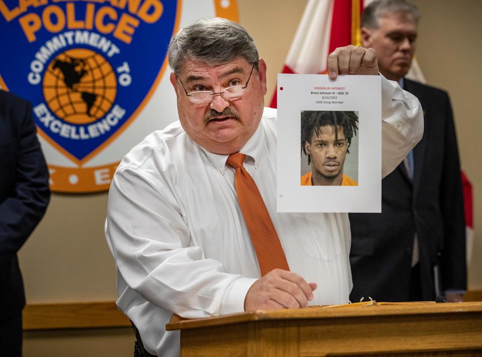 Lakeland Police Chief Sam Taylor holds up a photo of a suspect involved in the recent drive-by shooting.