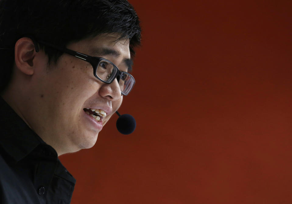 In this Dec. 9, 2013 photo, English grammar tutor Tony Chow gives a lesson to his students in a classroom of Modern Education in Hong Kong. The 30-year-old teaches English grammar to thousands of secondary school pupils, who attend his after-school lessons or watch video replays of them at Modern Education’s 14 branches. Chow is a celebrity tutor in Hong Kong, where there’s big money to be made offering extracurricular lessons to parents desperately seeking an edge for their children preparing for the city’s intense public entrance exam for university. (AP Photo/Kin Cheung)