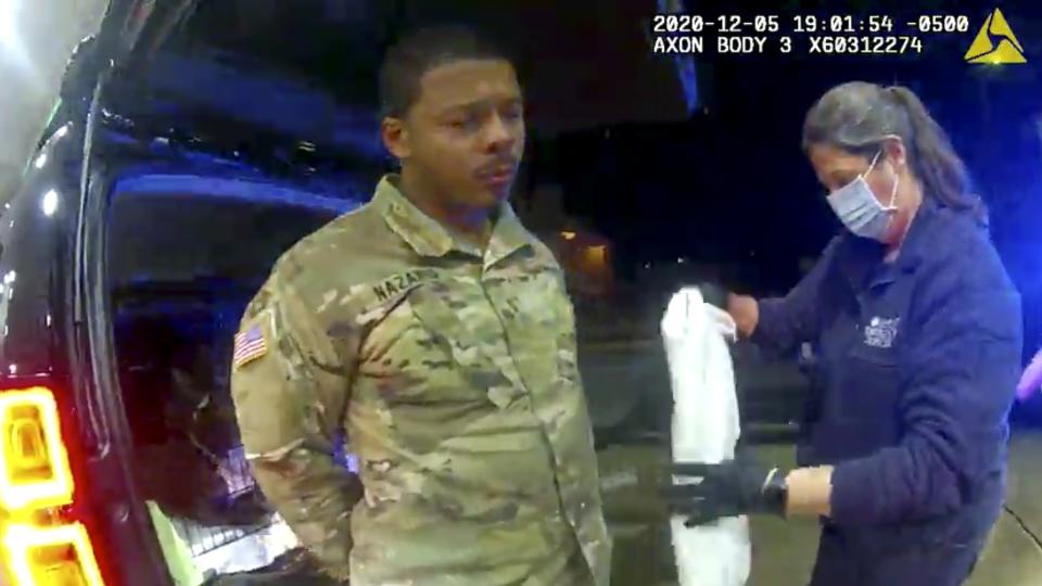 In this image made from Windsor, (Va.) Police video, Caron Nazario is helped by an EMT after he was sprayed with an agent by Windsor police after a traffic stop on Dec. 20, 2020, in Windsor, Va. Nazario, a second lieutenant in the U.S. Army, is suing two Virginia police officers over a traffic stop during which he says the officers drew their guns and pointed them at him as he was dressed in uniform. Caron Nazario says his constitutional rights were violated by the traffic stop in the town of Windsor in December. (Windsor Police via AP)