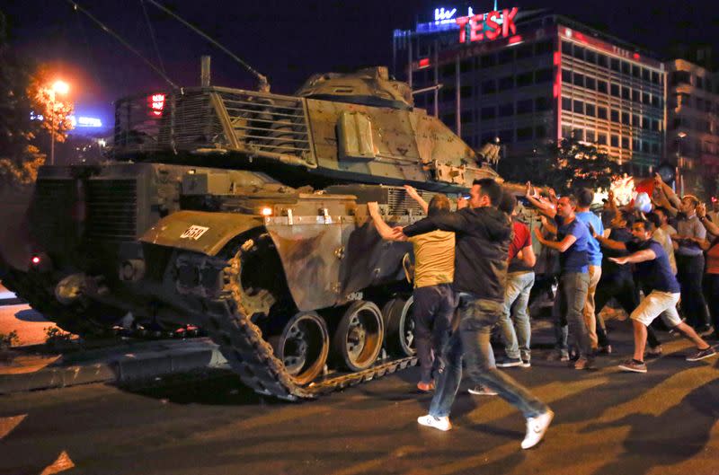 FILE PHOTO: People react near a military vehicle during an attempted coup in Ankara