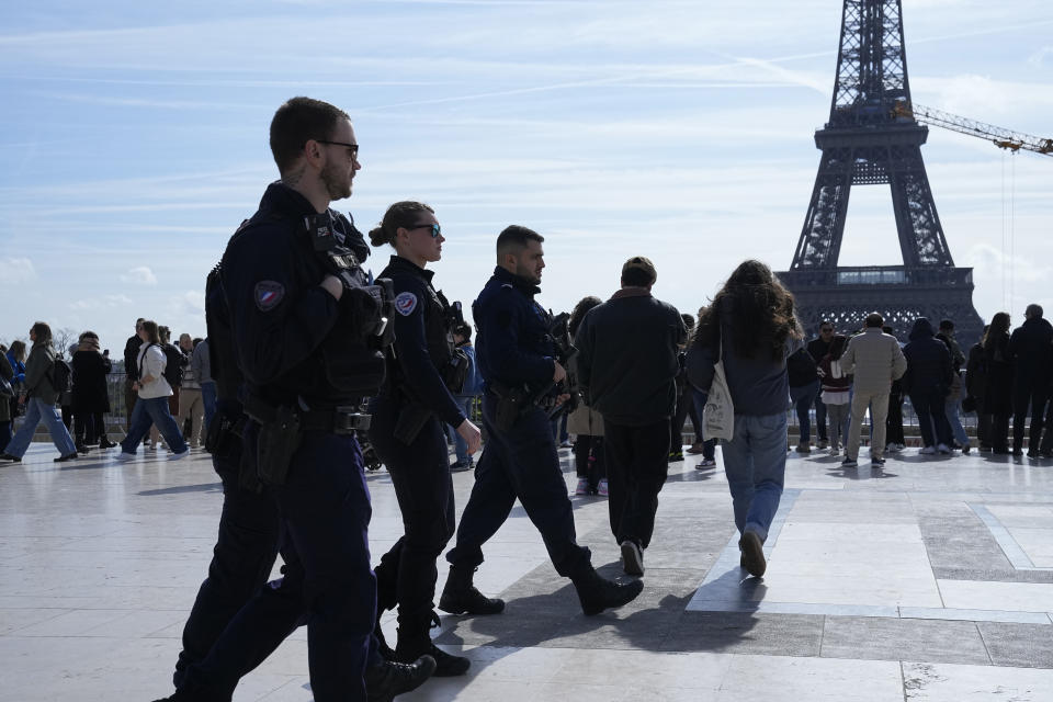 Police officers patrol on the Trocadero square Monday, March 25, 2024 in Paris. France's government increased its security alert posture to the highest level Sunday March 24, 2024 after the deadly attack at a Russian concert hall and the Islamic State's claim of responsibility. (AP Photo/Michel Euler)
