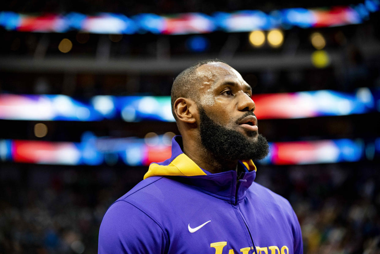 Los Angeles Lakers forward LeBron James (6) stands with his teammates during the singing of the national anthem prior to the start of an NBA basketball game against the Dallas Mavericks in Dallas, Sunday, Dec. 25, 2022. (AP Photo/Emil T. Lippe)