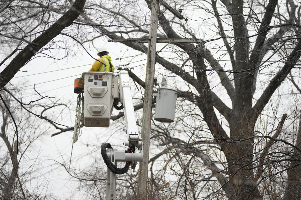 A DTE contractor crew works on a power line, Monday, Feb. 27, 2023, in northwest Detroit. Some Michigan residents faced a fourth straight day without power as crews worked to restore electricity to more than 165,000 homes and businesses in the Detroit area after last week's ice storm. (AP Photo/Carlos Osorio)