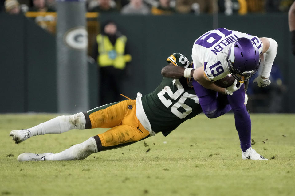 Minnesota Vikings wide receiver Adam Thielen (19) is tackled by Green Bay Packers safety Darnell Savage (26) after catching a pass during the second half of an NFL football game, Sunday, Jan. 1, 2023, in Green Bay, Wis. (AP Photo/Morry Gash)