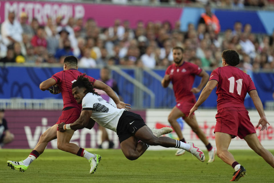 Fiji's Selestino Ravutaumada tackles Georgia's Luka Matkava during the Rugby World Cup Pool C match between Fiji and Georgia at the Stade de Bordeaux in Bordeaux, France, Saturday, Sept. 30, 2023. (AP Photo/Thibault Camus)