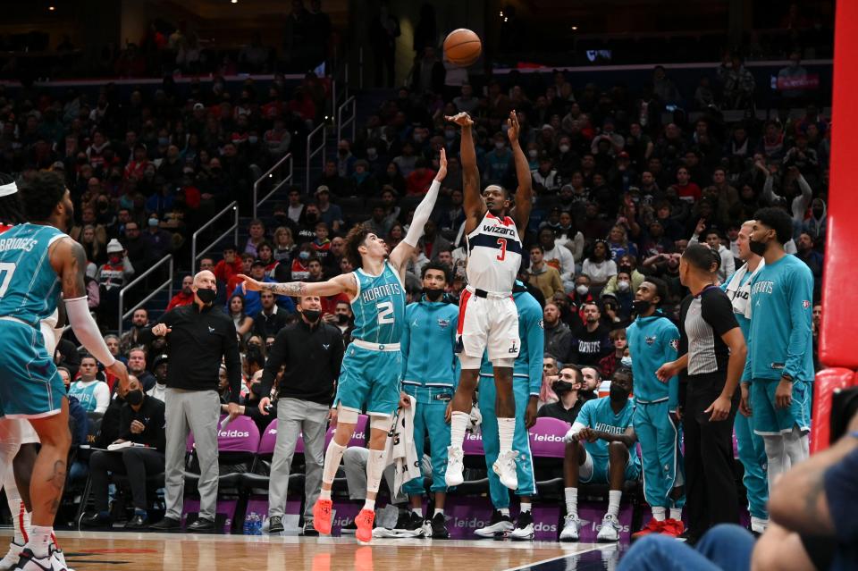 Washington Wizards guard Bradley Beal (3) shoots a 3-pointer as Charlotte Hornets guard LaMelo Ball (2) defends during the second half at Capital One Arena.