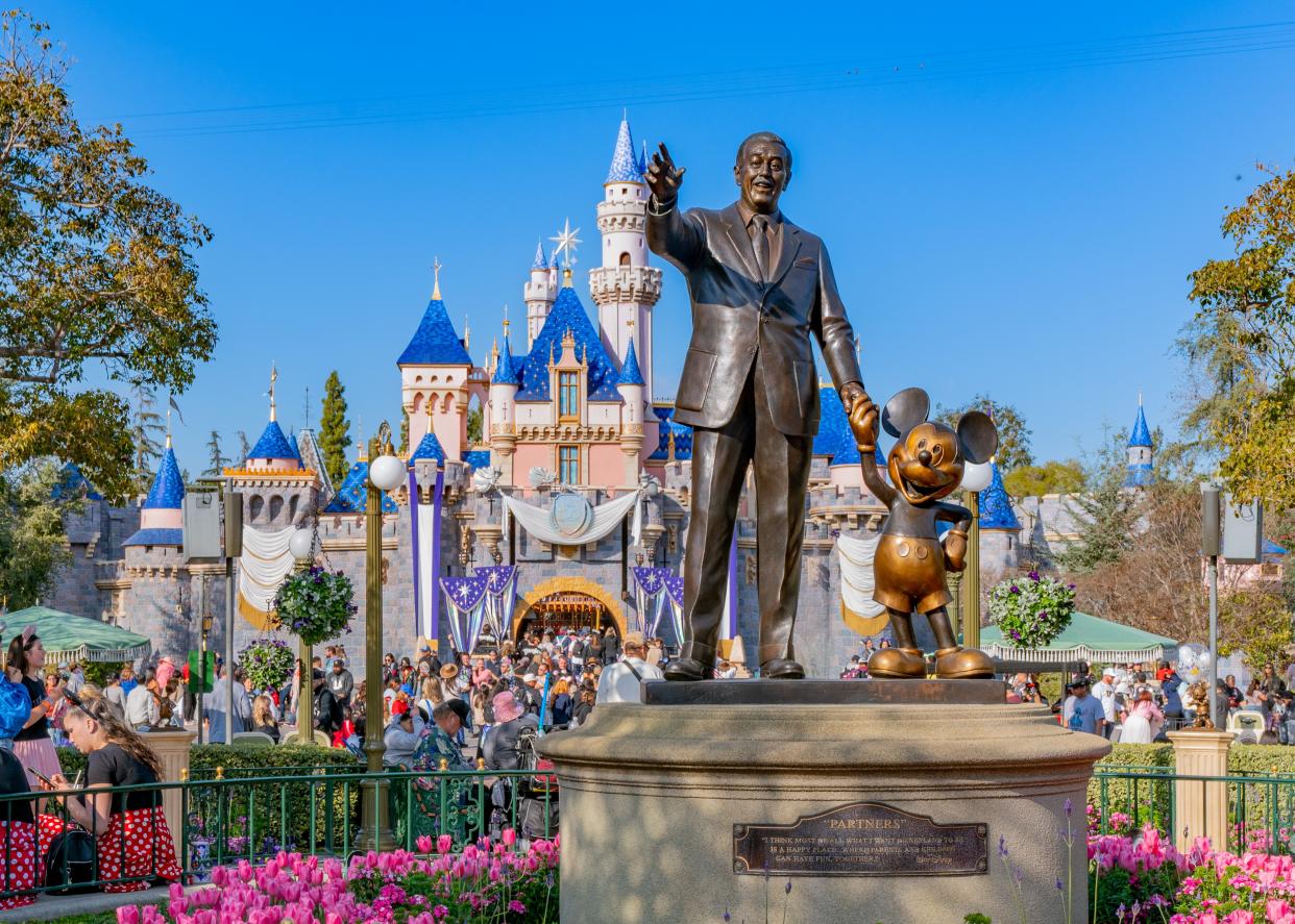 The Walt Disney 'Partners' statue, featuring Mickey Mouse holding hands with Walt Disney in front of the Magic Kingdom Palace at Disneyland in Anaheim
