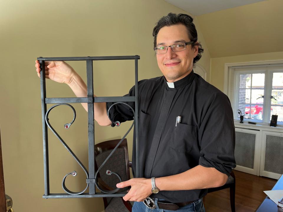 The Rev. Caleb PItkin of First United Methodist Church holds up an item he recently made as part of his blacksmithing hobby.