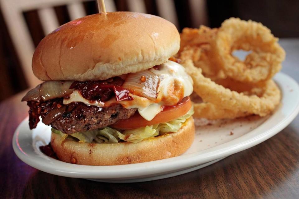 Popular entrees including the Diablo Burger with onion rings at Fred’s Texas Cafe in Fort Worth.