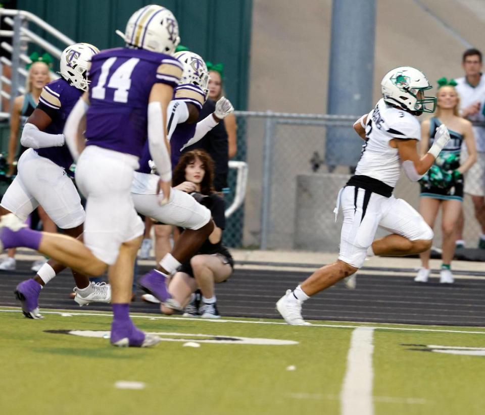 Carroll running back Davis Penn (3) races down the side lines for a Dragon touchdown in the first half of a UIL high school football game at Keller ISD Stadium in Keller, Texas, Thursday, Sept. 14, 2023. Bob Booth/Special to the Star-Telegram