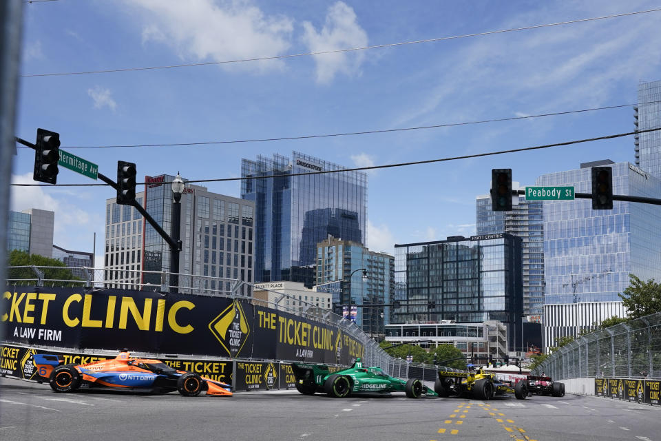 FILE - IndyCar drivers driver Felix Rosenqvist (6) and Marcus Armstrong (11) make their way through Turn 7 during the Music City Grand Prix auto race Sunday, Aug. 6, 2023, in Nashville, Tenn. IndyCar will move its September season-ending championship finale from the downtown streets of Nashville to the superspeedway in Lebanon because of construction surrounding the Tennessee Titans new NFL stadium, organizers announced Wednesday, Feb. 14, 2024. (AP Photo/George Walker IV)