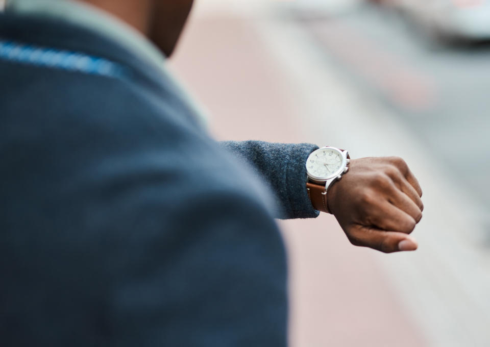 someone looking at their wrist watch