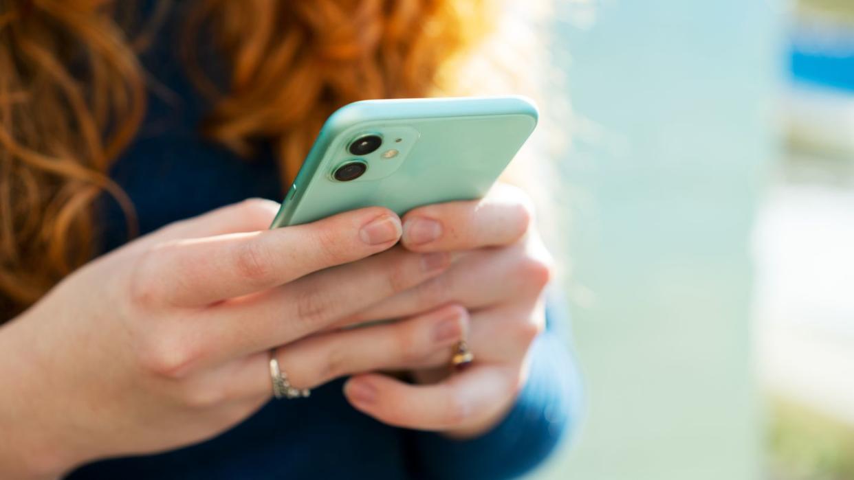 close up of woman using smartphone