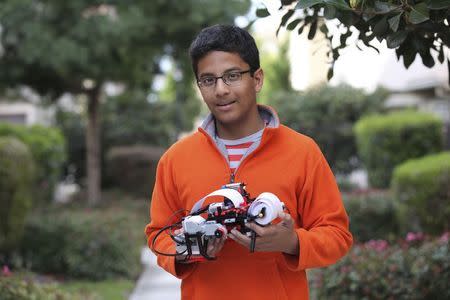 Shubham Banerjee, founder of Braigo Labs Inc., holds a printer in Palo Alto, California, in this 2014 handout photo provided by Braigo Labs Inc. REUTERS/Braigo Labs Inc./Handout via Reuters