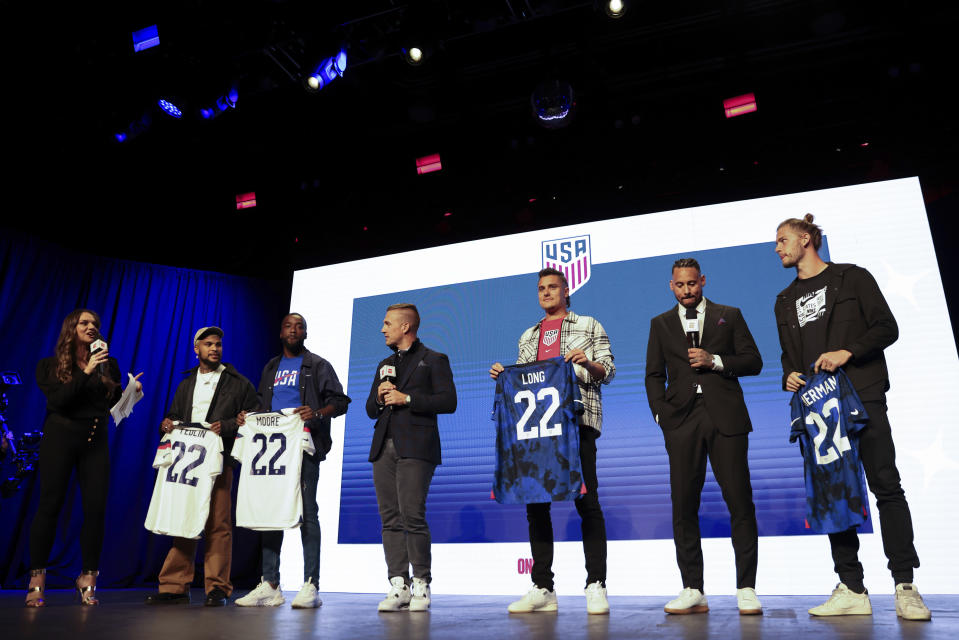 United States soccer players DeAndre Yedlin, Shaq Moore, Aaron Long and Walker Zimmerman hold up jerseys, Wednesday, Nov. 9, 2022, in New York, after being introduced announced as defenders on the U.S. men's national soccer roster for the upcoming World Cup in Qatar. (AP Photo/Julia Nikhinson)