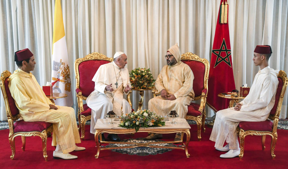 Pope Francis, centre left is received by Morocco's King Mohammed VI centre right, his son Crown Prince Moulay Hassan right, and brother Prince Moulay Rachid, left, in Rabat, Saturday, March 30, 2019. Pope Francis has arrived in Morocco for a trip aimed at highlighting the North African nation's tradition of Christian-Muslim ties, while also letting him show solidarity with migrants at Europe's door and tend to a tiny Catholic flock. (Fadel Senna/Pool Photo via AP)