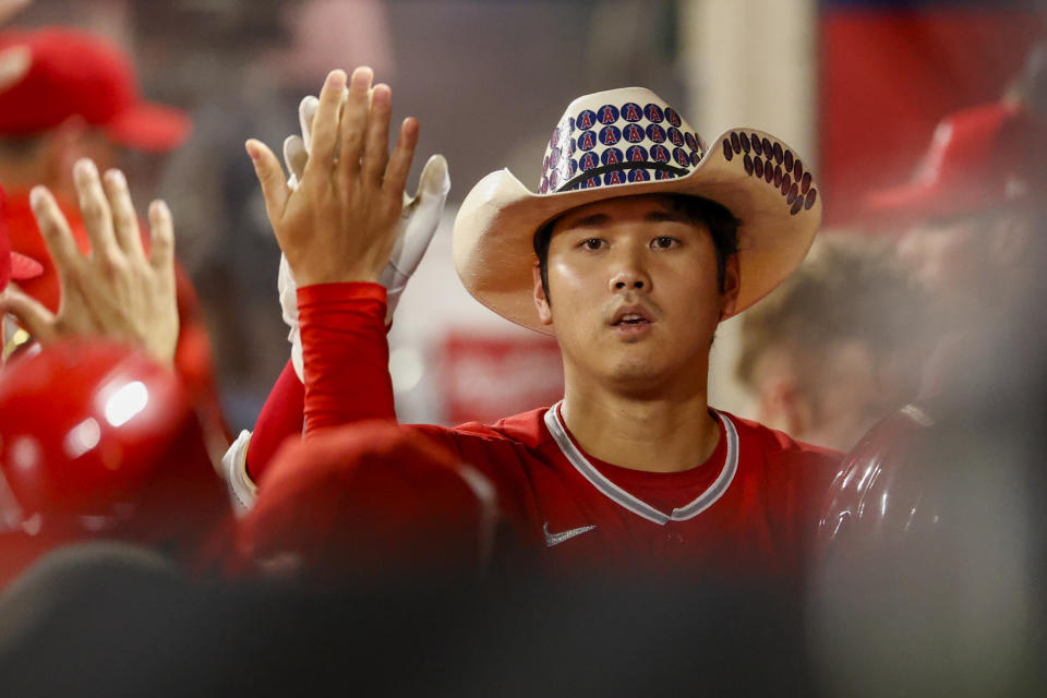 Los Angeles Angels' Shohei Ohtani celebrates in the dugout after hitting a two-run home run during the third inning of a baseball game against the Detroit Tigers in Anaheim, Calif., Monday, Sept. 5, 2022. (AP Photo/Ringo H.W. Chiu)