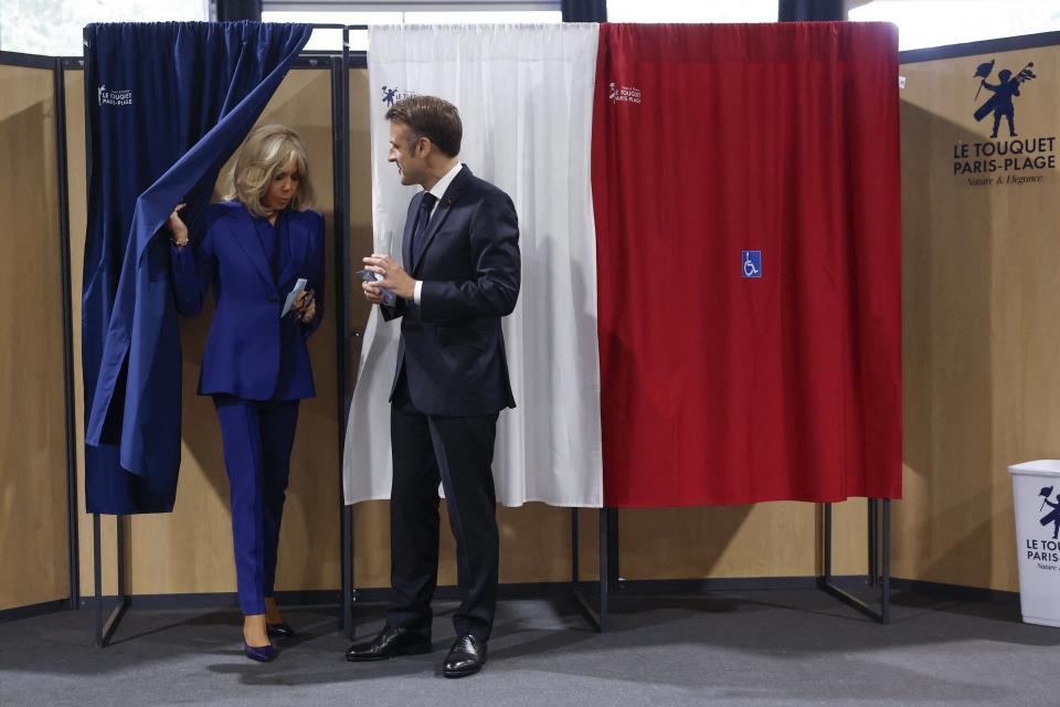 Emmanuel Macron and wife Brigitte voting on Sunday in the second round of French parliamentary elections (POOL/AFP via Getty Images)