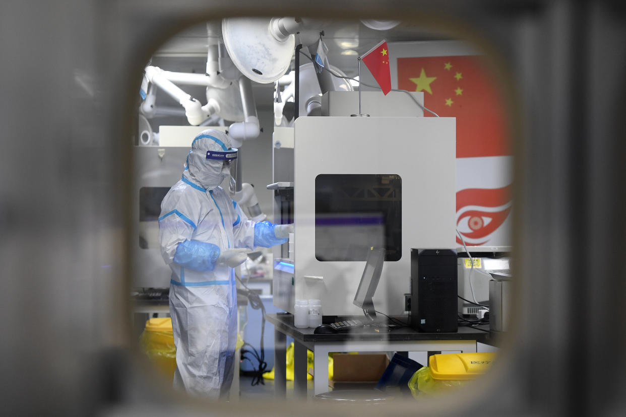 People in PPE work in the Huo-Yan (Fire Eye) Laboratory designed for high-capacity 2019-nCoV (SARS-CoV-2) detection in Wuhan in central China's Hubei province Thursday, Aug. 05, 2021. 