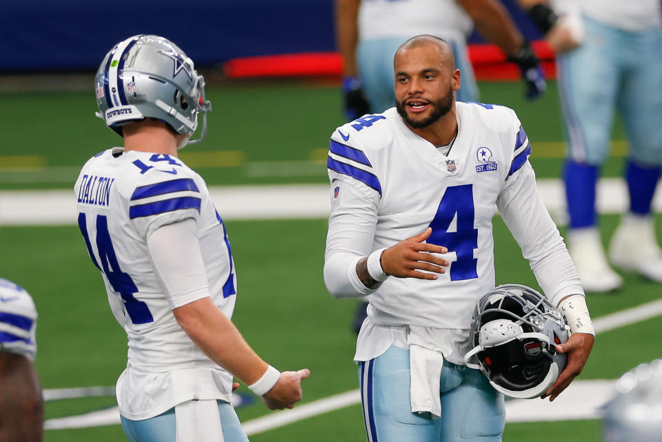 ARLINGTON, TX - OCTOBER 11: Dallas Cowboys Quarterback Dak Prescott (4) and Andy Dalton (14) talk prior to the NFL game between the New York Giants and Dallas Cowboys on October 11, 2020 at AT&T Stadium in Arlington, TX.  (Photo by Andrew Dieb/Icon Sportswire via Getty Images)