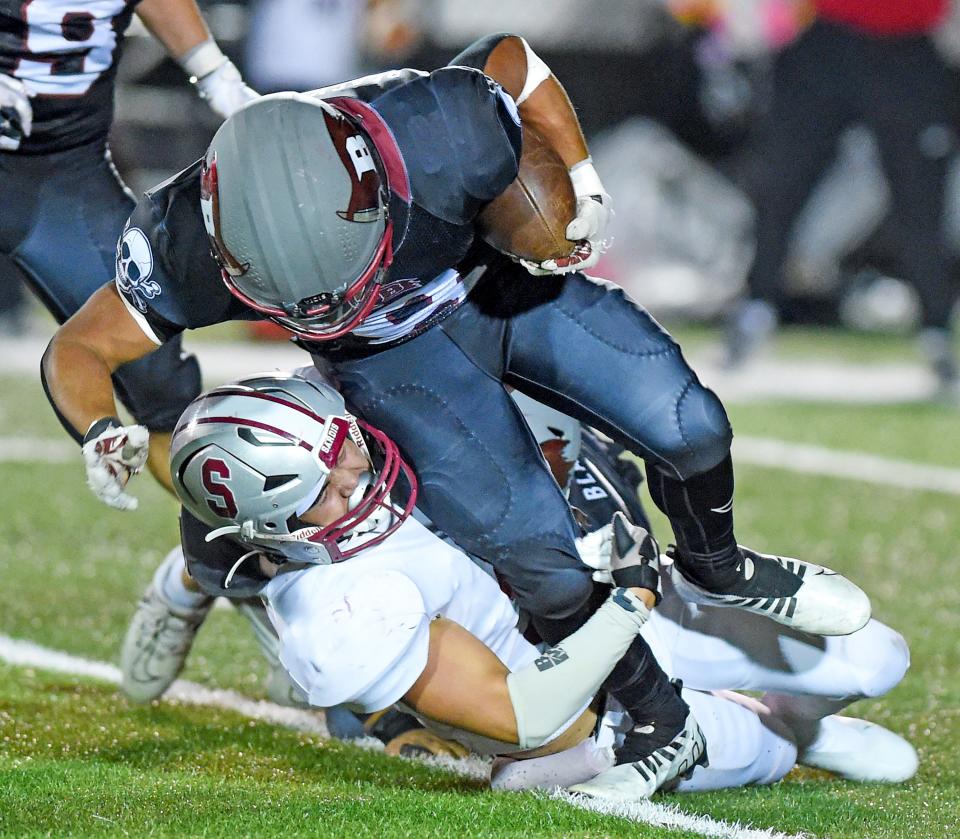 Boaz's Tristan Childers tries to evade the tackle of Sardis' Derek Tarvin during high school football action in Boaz, Alabama October 20, 2023.