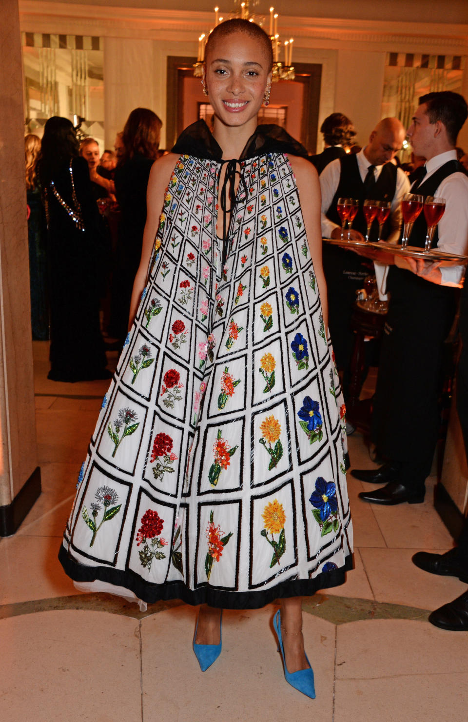 <p>The fashion model wore a one-of-a-kind <span>Mary Katrantzou gown paired with bright blue heels for the Claridge’s event. </span><em>[Photo: Getty]</em> </p>