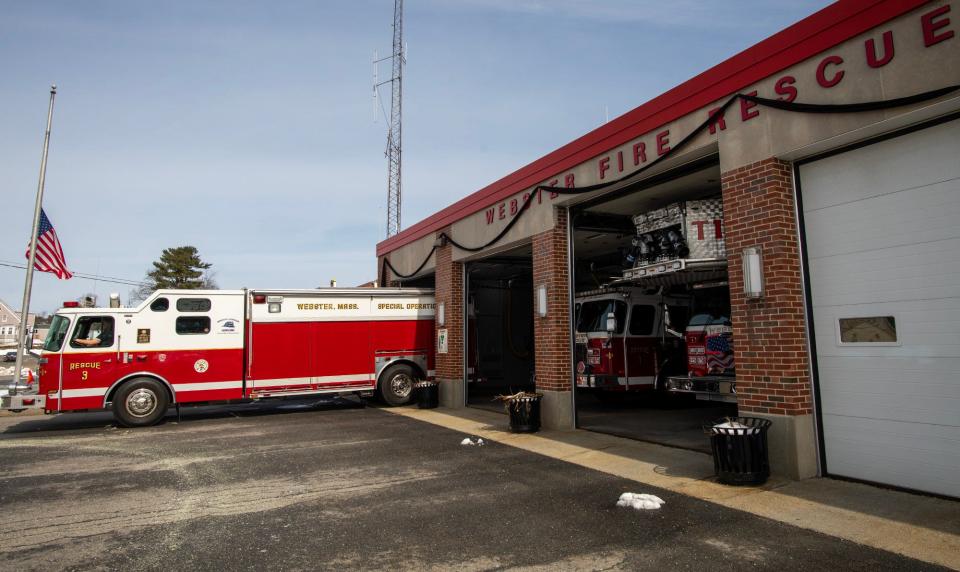 The American flag is at half-staff and black bunting decorates the front of the Webster Fire Dept. headquarters Wednesday in honor of the death of Firefighter Paul Cloutier last week.