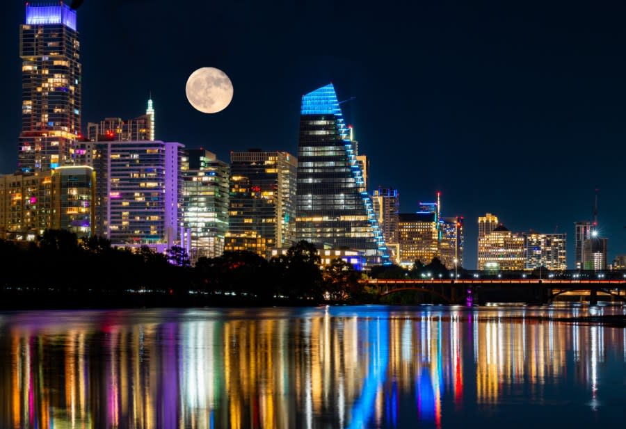 The moon and the Austin skyline reflect in Lady Bird Lake on Aug. 3, 2023, as seen from Lou Neff Point. The August 2023 KXAN Viewer Photo of the Month winner. (KXAN Viewer Photo)