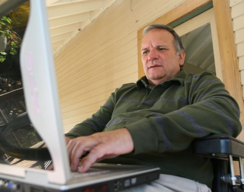 Novelist David Rhodes works on the porch of his home near Wonewoc.