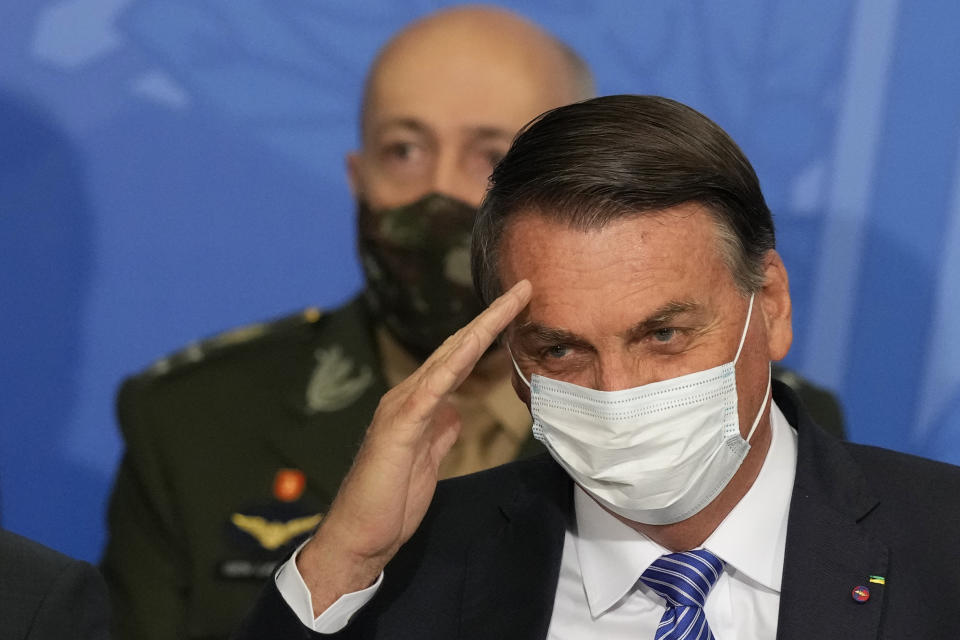 Brazil's President Jair Bolsonaro salutes, as Army Commander Paulo Sergio Nogueira de Oliveira stands behind him during a swearing-in ceremony at the Planalto presidential palace, in Brasilia, Brazil, Wednesday, Aug. 4, 2021. (AP Photo/Eraldo Peres)