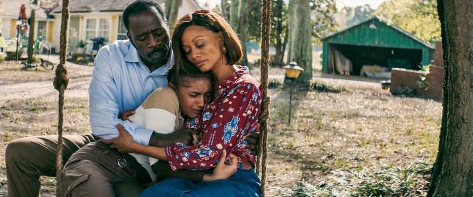 The Rev. W.C. Martin (played by Demetrius Grosse) and wife Donna Martin (Nika King) hold their adopted daughter Terri (Diaana Babnicova) in "Sound of Hope: The Story of Possum Trot."