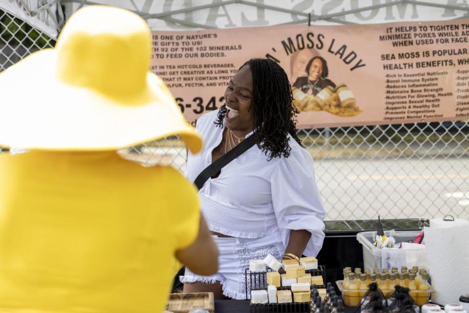 Gwendolyn Moseley talks to customers at her stand