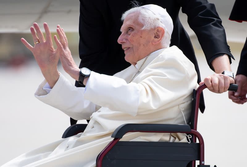 Pope Emeritus Benedict XVI gestures at the Munich Airport before his departure to Rome