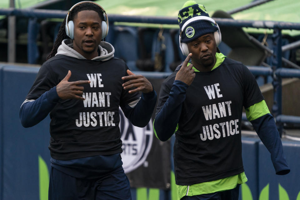 FILE - Seattle Seahawks cornerback Shaquill Griffin, left, and linebacker Shaquem Griffin are shown during warmups before an NFL football game against the Lost Angeles Rams in Seattle, in this Sunday, Dec. 27, 2020, file photo. The Griffin twins are already talking trash three months before they’re on opposite sidelines for the first time in their lives. Shaquill and Shaquem Griffin were teammates at every level of football growing up in St. Petersburg. They also played together at UCF and with the Seattle Seahawks the last three years. The seemingly inseparable brothers hit free agency in March and hoped to be reunited again. But it didn’t work out. (AP Photo/Stephen Brashear, File)