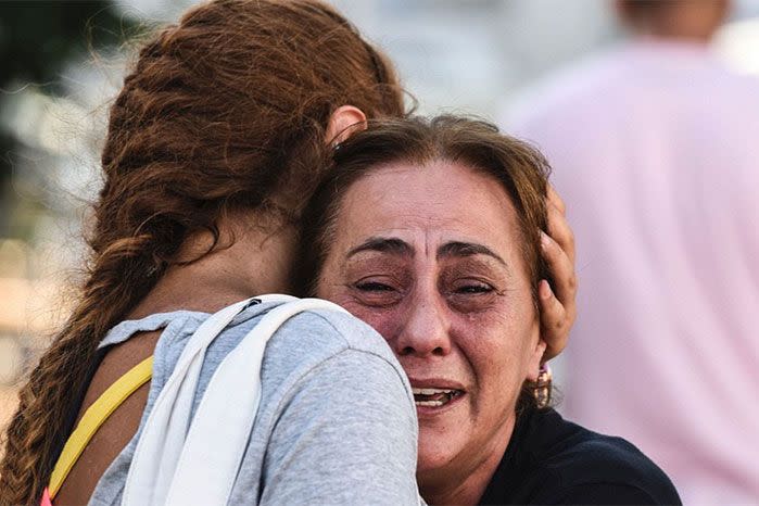 A mother of one of the victims is comforted after the attack. Photo: Getty