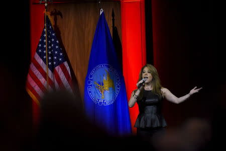 Angie Johnson sings the National Anthem during the National Rifle Association's annual meeting in Nashville, Tennessee April 10, 2015. REUTERS/Harrison McClary