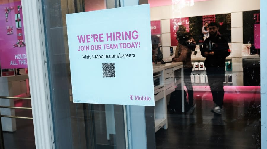 <sub> A hiring sign is displayed in a window of a store in Manhattan on December 02, 2022 in New York City. (Photo by Spencer Platt/Getty Images)</sub>