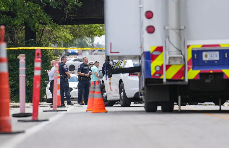 Officers and detectives gather at the scene where a suspect crashed a jail wagon after stealing it Monday, July 10, 2023, on Prospect Street just outside the Community Justice Campus in Indianapolis. Marion County Sheriff's Office Deputy John Durm was killed in the escape attempt.