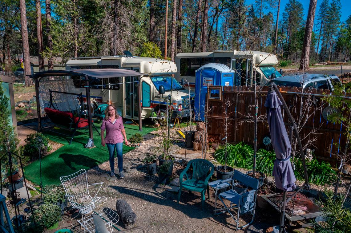 Camp Fire survivor Skeeter Schuette walks with her dog Ethel on her property in Paradise on Wednesday, March 9, 2022.